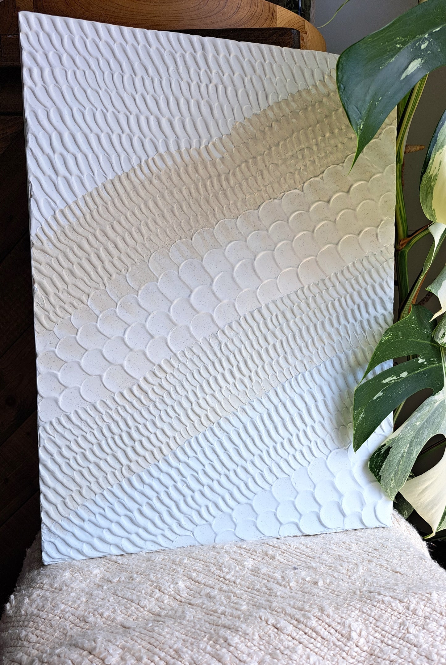 Handmade textured pattern art with sandy beige and light blue tones for a beachy feel.