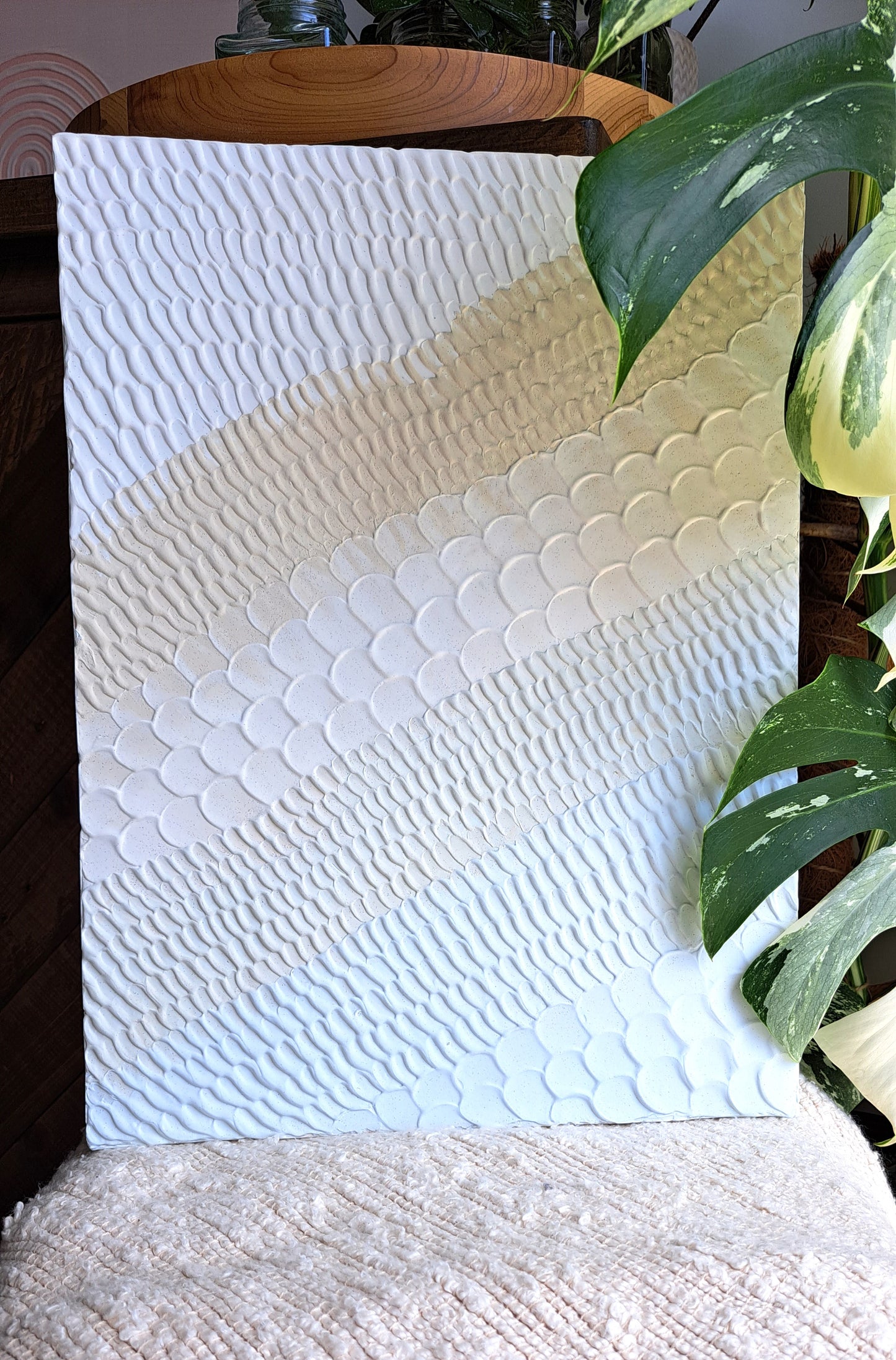 Handmade textured pattern art with sandy beige and light blue tones for a beachy feel.