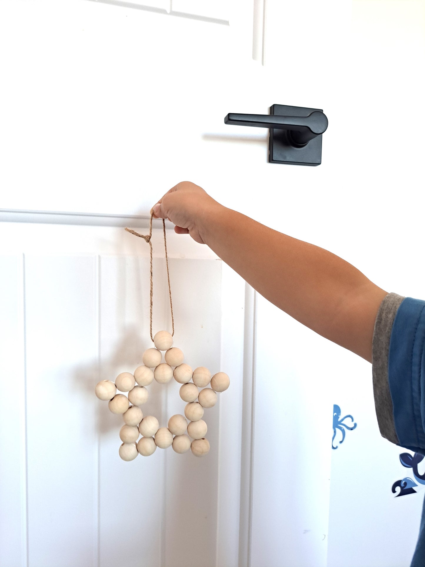 Weathered Landing's handmade wooden bead star. Beautiful in a nursery for a Scandi, boho, or modern farmhouse feel. Works great with neutral decor and is made with wood and jute. Find wooden bead stars at Weathered Landing. Located in Komoka, Ontario. Shipping to Canada and US.
