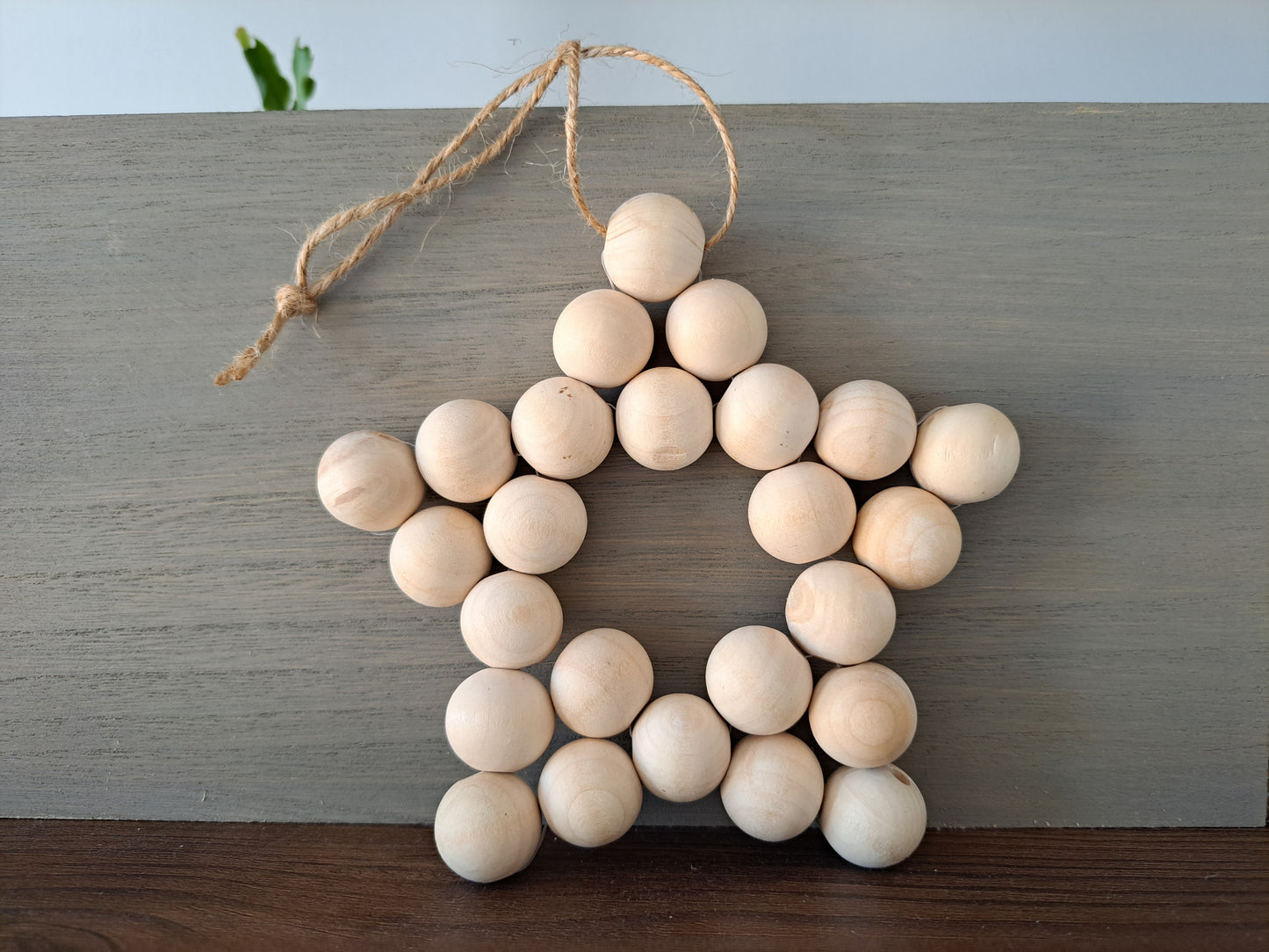 Weathered Landing's handmade wooden bead star. Beautiful in a nursery for a Scandi, boho, or modern farmhouse feel. Works great with neutral decor and is made with wood and jute. Find wooden bead stars at Weathered Landing. Located in Komoka, Ontario. Shipping to Canada and US.