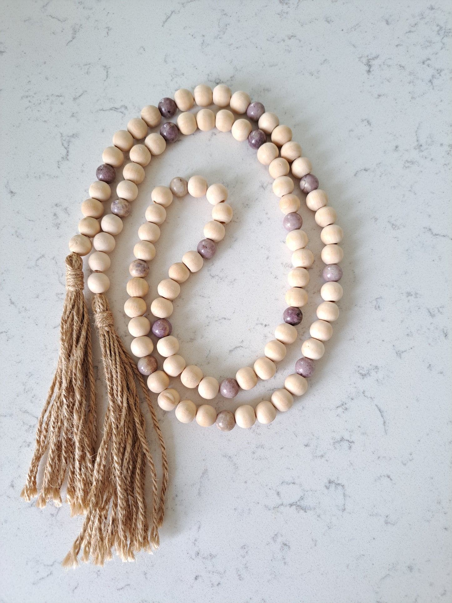 Weathered Landing's Lepidolite stone and wooden bead garland. Perfect in a farmhouse, country, boho, coastal, or rustic home. Find a variety of home decor and garlands at Weathered Landing. Located in Komoka, Ontario, local delivery is available. Shipping to Canada and the US.