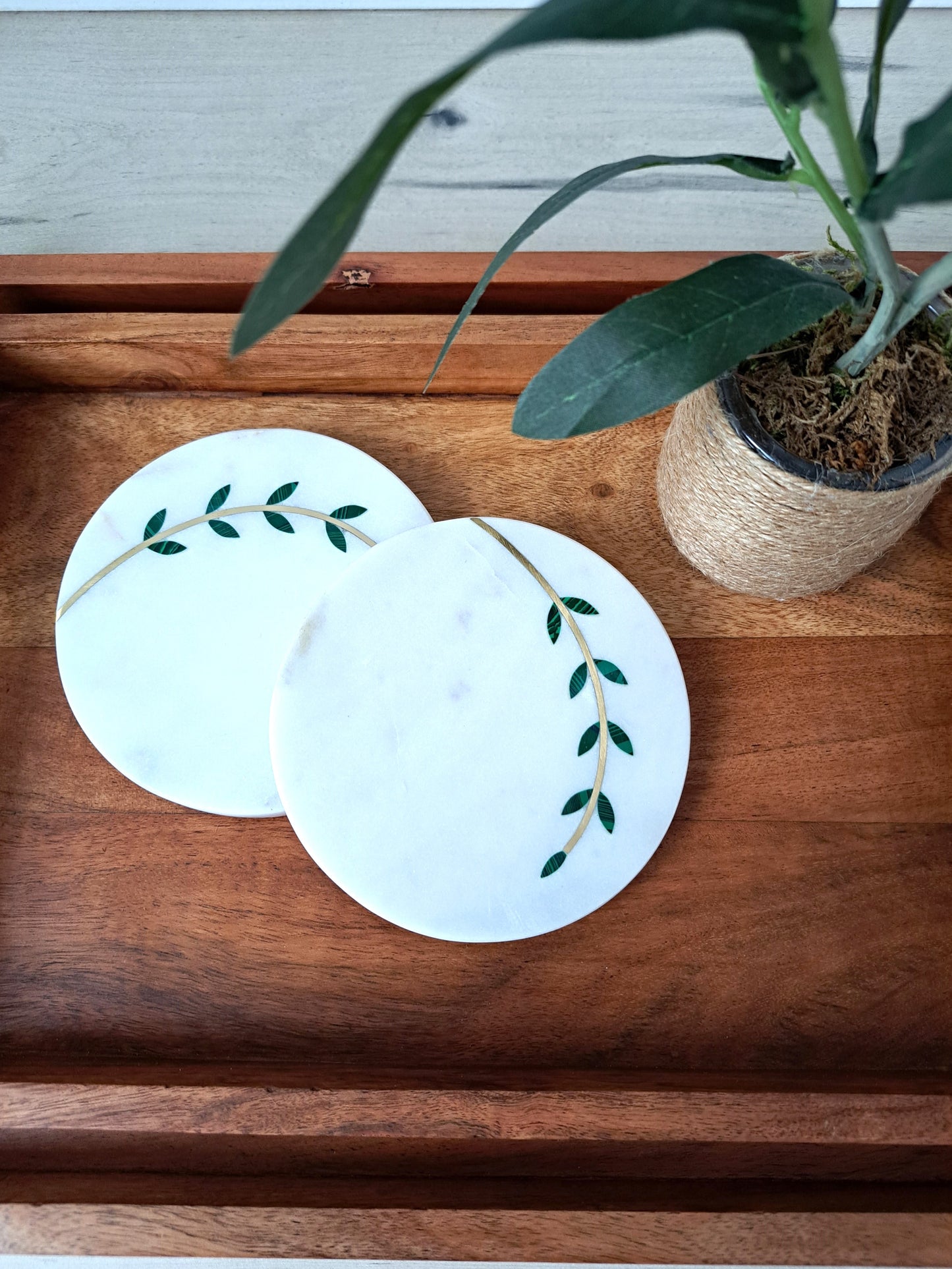 Hand-cut, artisan crafted olive branch coasters. Minimal yet stunning, these coasters made of white marble with brass inlay are sure to impress. Beautiful for a farmhouse, Mediterranean, or contemporary space.