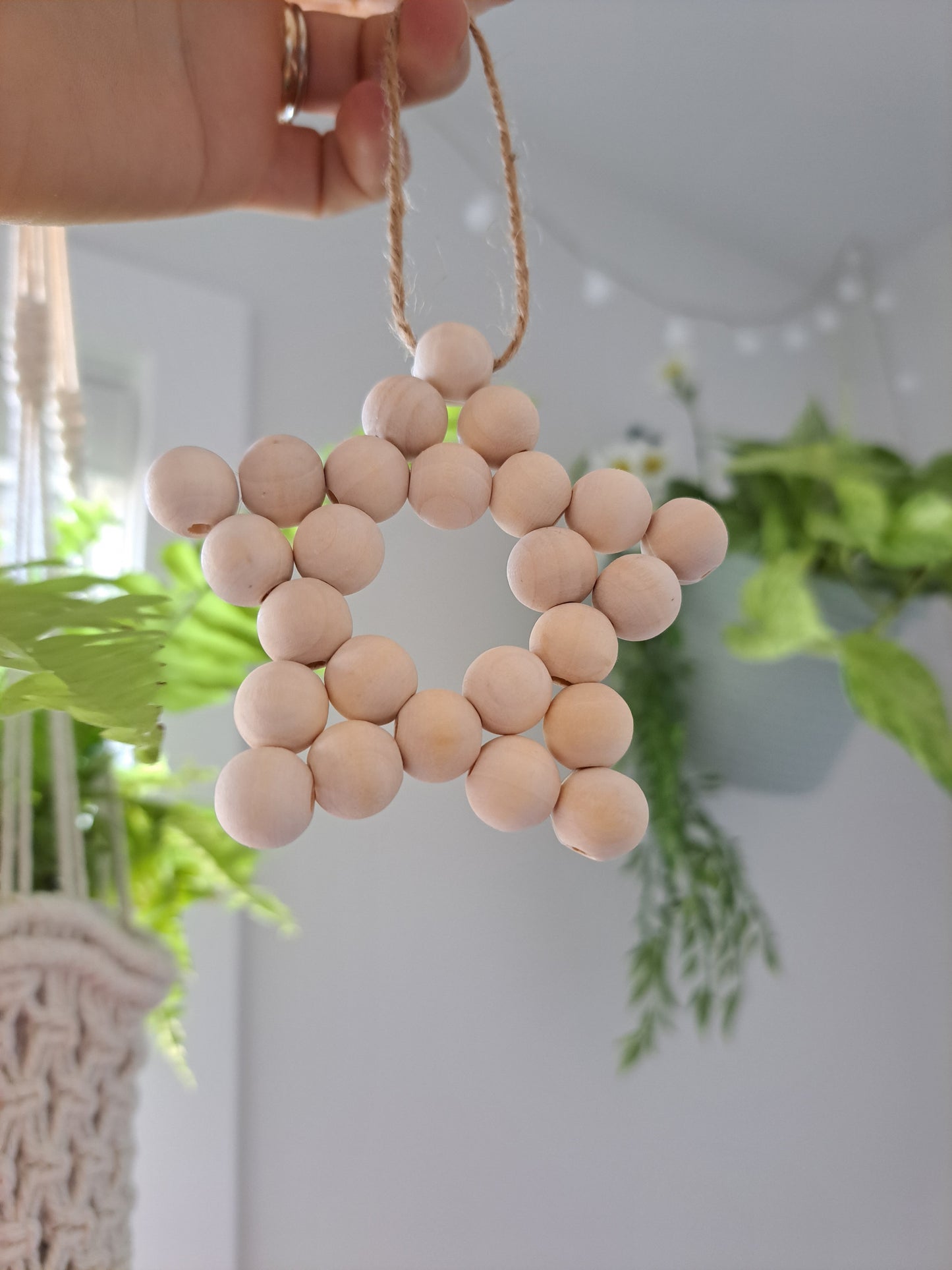 Weathered Landing's handmade wooden bead star. Beautiful in a nursery for a Scandi, boho, or modern farmhouse feel. Works great with neutral decor and is made with wood and jute. Find wooden bead stars at Weathered Landing. Located in Komoka, Ontario. Shipping to Canada and US.