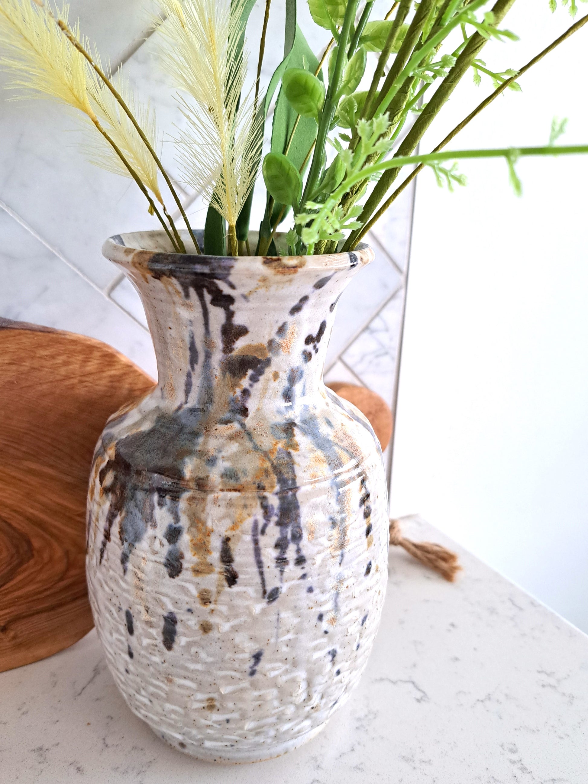 Weathered Landing's handmade ceramic splash vase. Artist signed pottery made in Canada. A great way to showcase your florals and stems. Beautiful for an urban, modern, and contemporary home. Find a variety of home decor, plants and wall art at Weathered Landing. Located in Komoka, Ontario, local delivery is available. Shipping to Canada and the US.