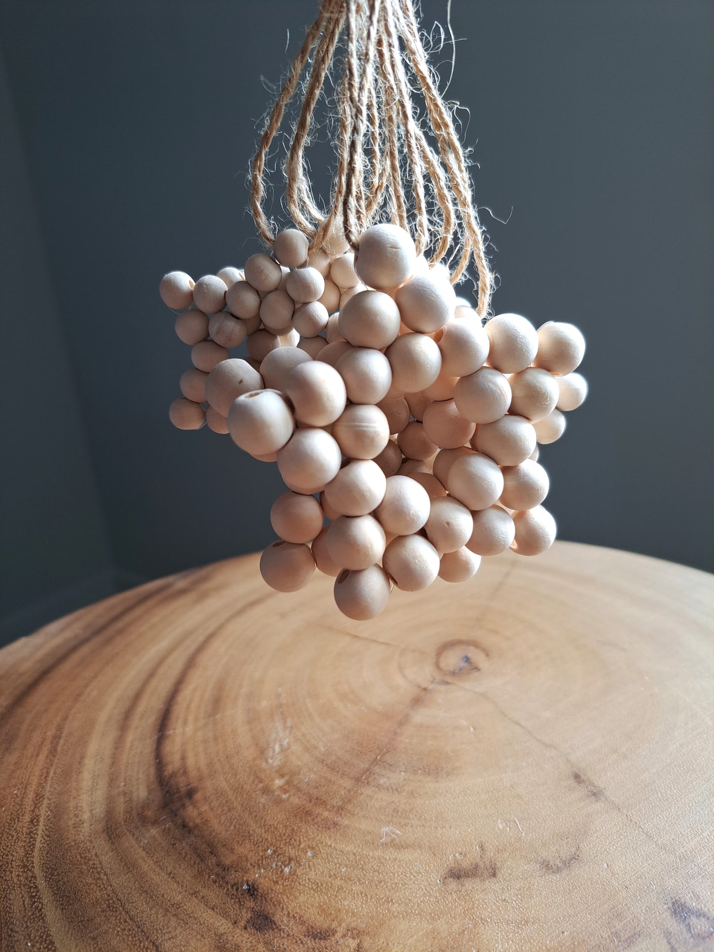 Weathered Landing's handmade wooden bead star. Beautiful in a nursery for a Scandi, boho, or modern farmhouse feel. Works great with neutral decor and is made with wood and jute. Find wooden bead stars at Weathered Landing. Located in Komoka, Ontario. Shipping to Canada and US.