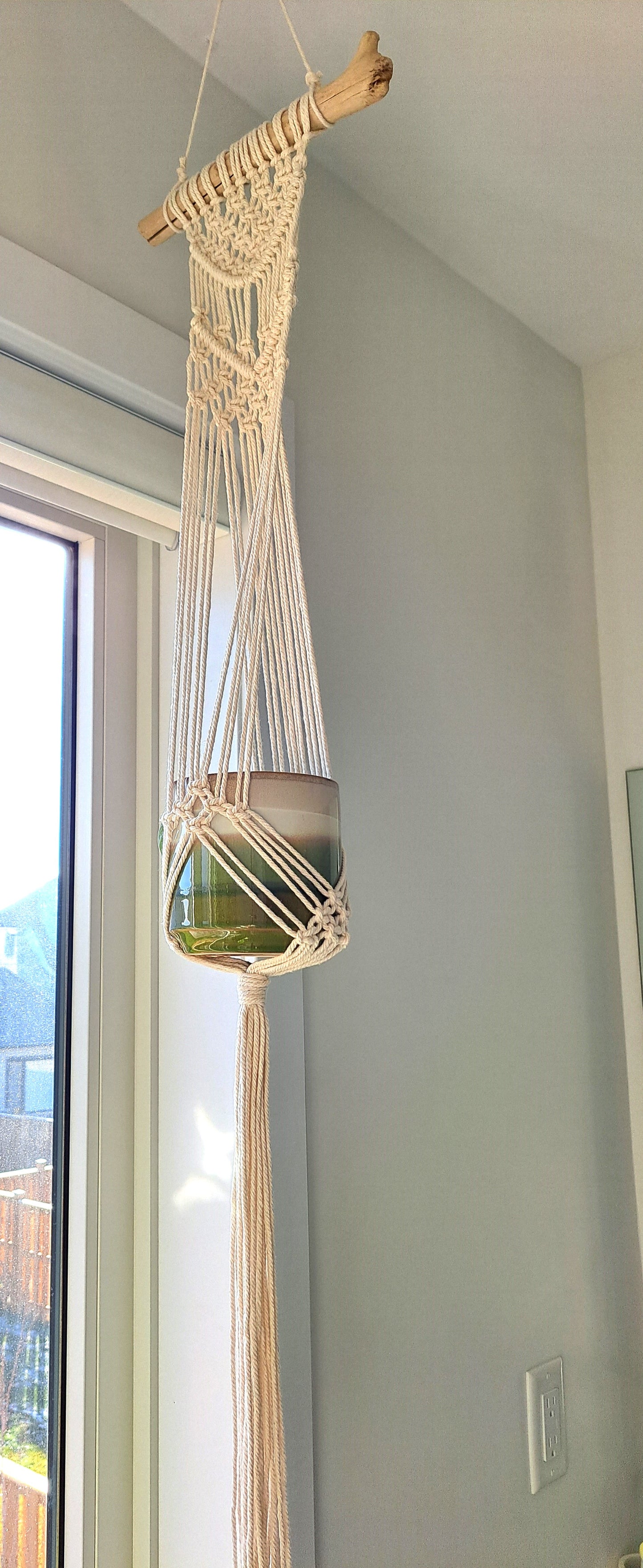 Weathered Landing's handmade driftwood macrame plant hanger that fits a 4 inch pot best. Display your hanging plants in this intricate boho plant hanger. Adds texture and natural elements to your space. Located in Komoka. Shipping to Canada and US.