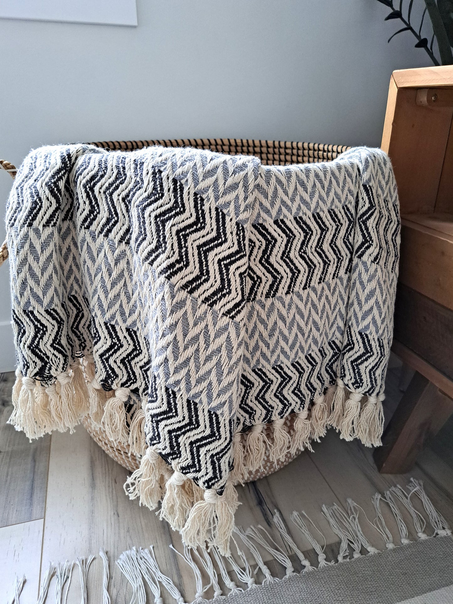 An incredibly soft and warm throw, this handwoven 100% cotton blanket adds so much texture to the space. Made with a chevron pattern, the neutral beige, grey, and subtle blue provide lots of visual interest by providing a bold, yet calming overall look. Truly an artisanal piece, and one that is sure to impress!