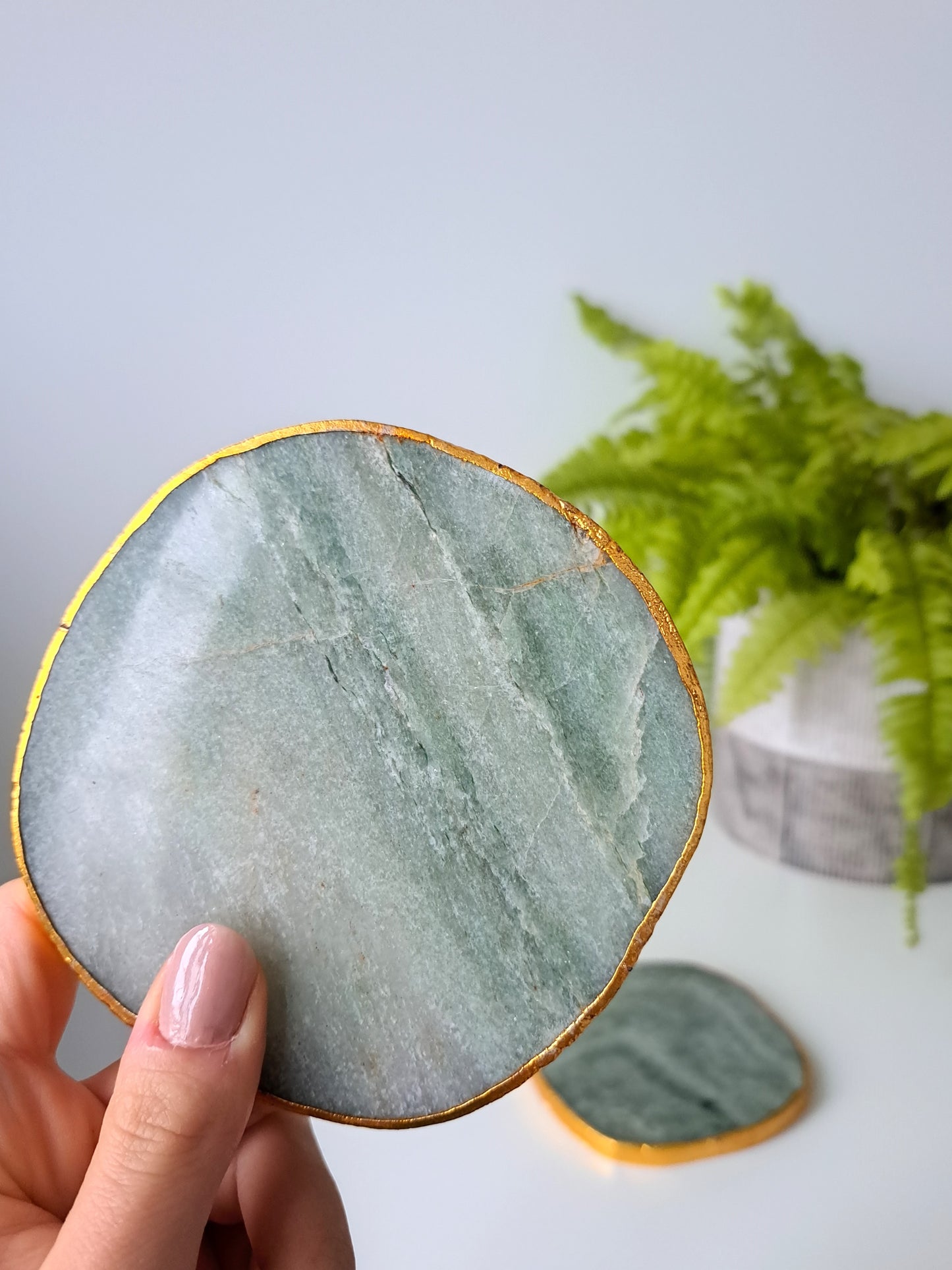 Artisanal, handmade agate coaster. Made with agate stone, this coaster has a beautiful shine to it. Formed within volcanic and metamorphic rocks, the use of agate in crafting decorative items dates back to ancient Greek civilizations. Agate is also known for it's strength and ability to retain a smooth polish, making it a very functional material.