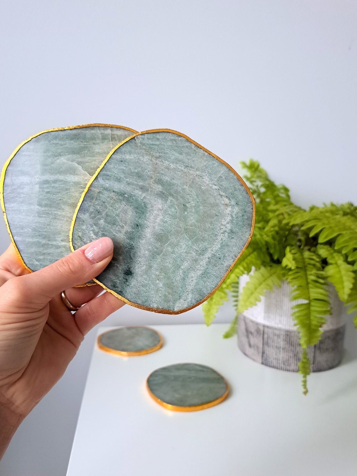 Artisanal, handmade agate coaster. Made with agate stone, this coaster has a beautiful shine to it. Formed within volcanic and metamorphic rocks, the use of agate in crafting decorative items dates back to ancient Greek civilizations. Agate is also known for it's strength and ability to retain a smooth polish, making it a very functional material.