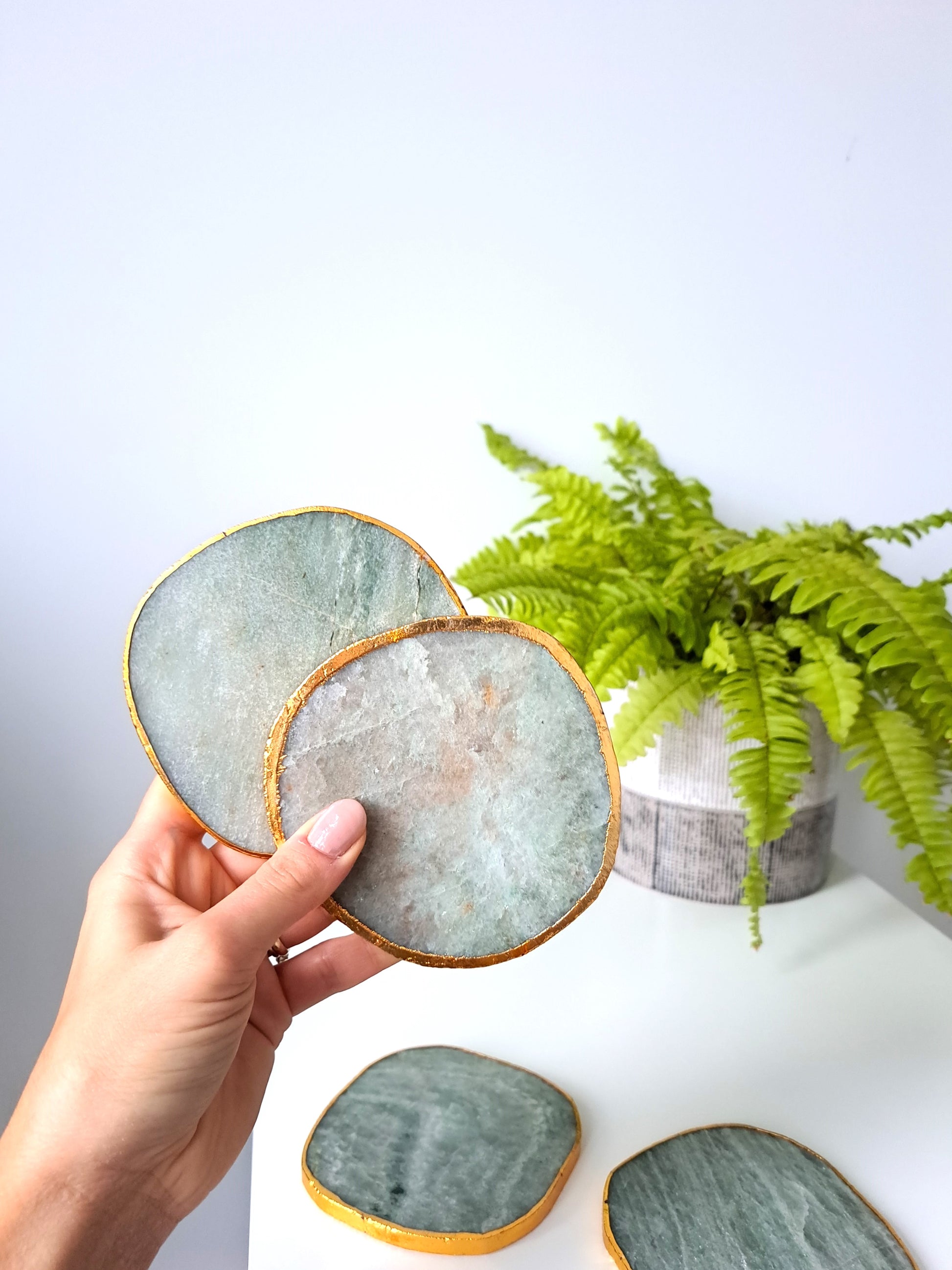 Artisanal, handmade agate coaster. Made with agate stone, this coaster has a beautiful shine to it. Formed within volcanic and metamorphic rocks, the use of agate in crafting decorative items dates back to ancient Greek civilizations. Agate is also known for it's strength and ability to retain a smooth polish, making it a very functional material.