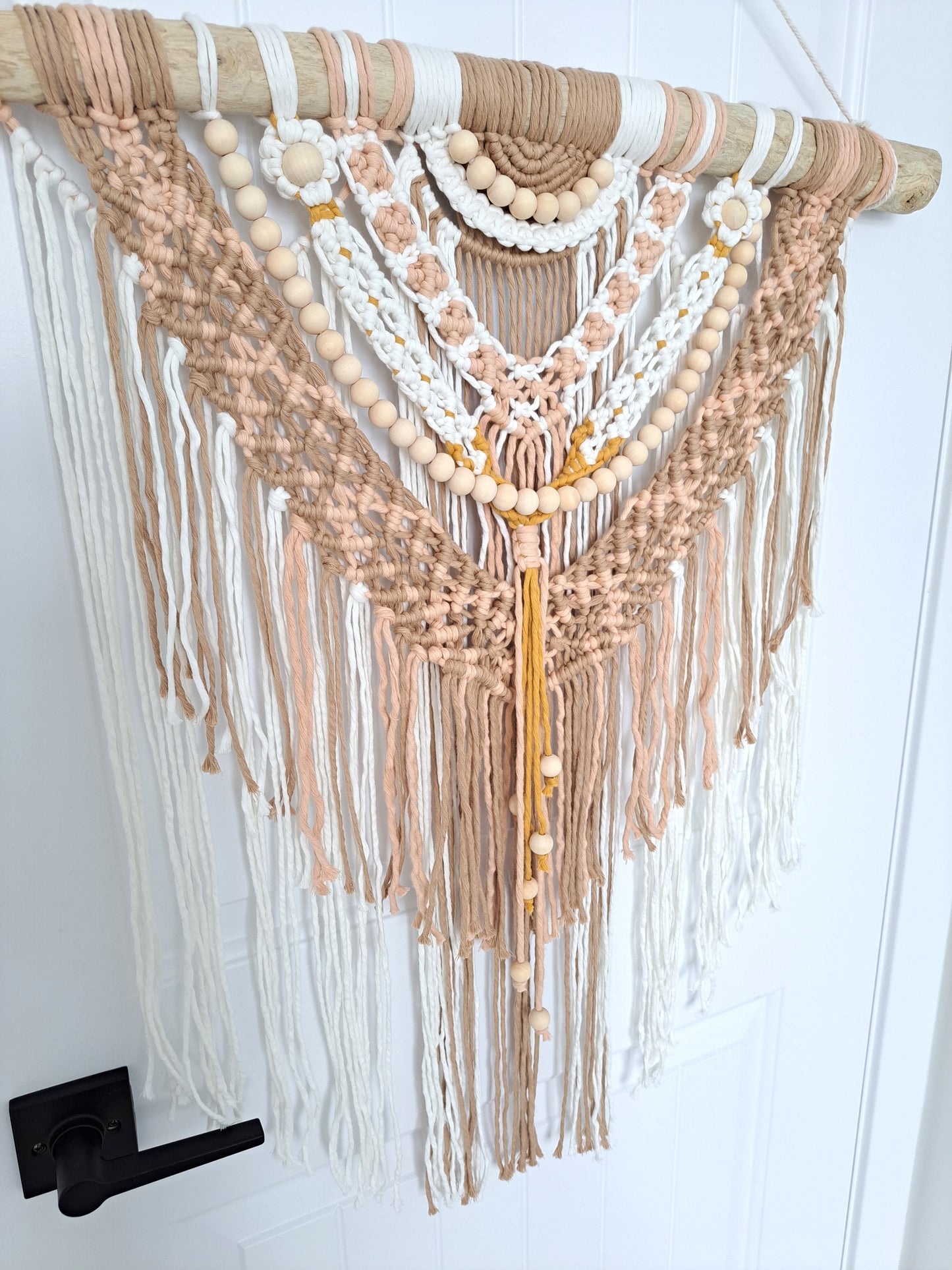 Boho Pink and Tan Macrame and Driftwood Wall Hanging. Bright and playful macrame wall hanging made with driftwood and wooden beads. Made with white, pink, tan, and mustard yellow cotton macrame.