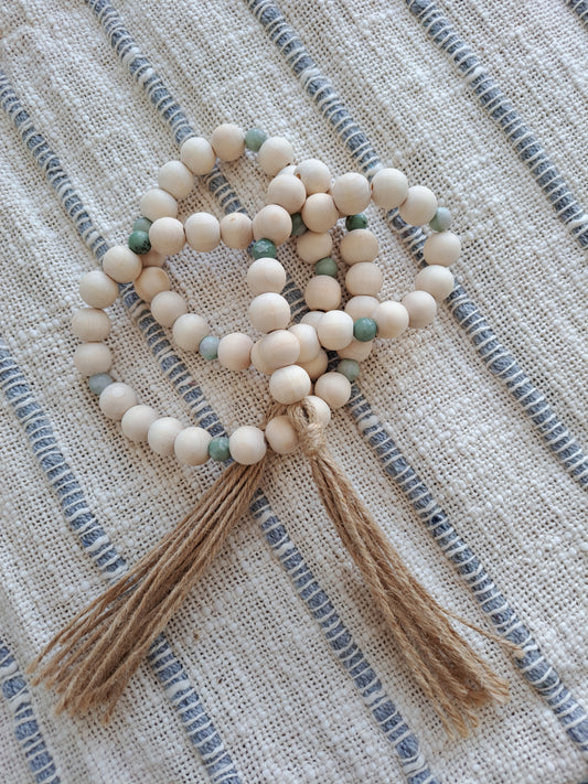 Weathered Landing's handmade garland with peace jade stone, wooden beads, and jute tassels. Perfect to complete a beach house or coastal look. Shipping to Canada and US.